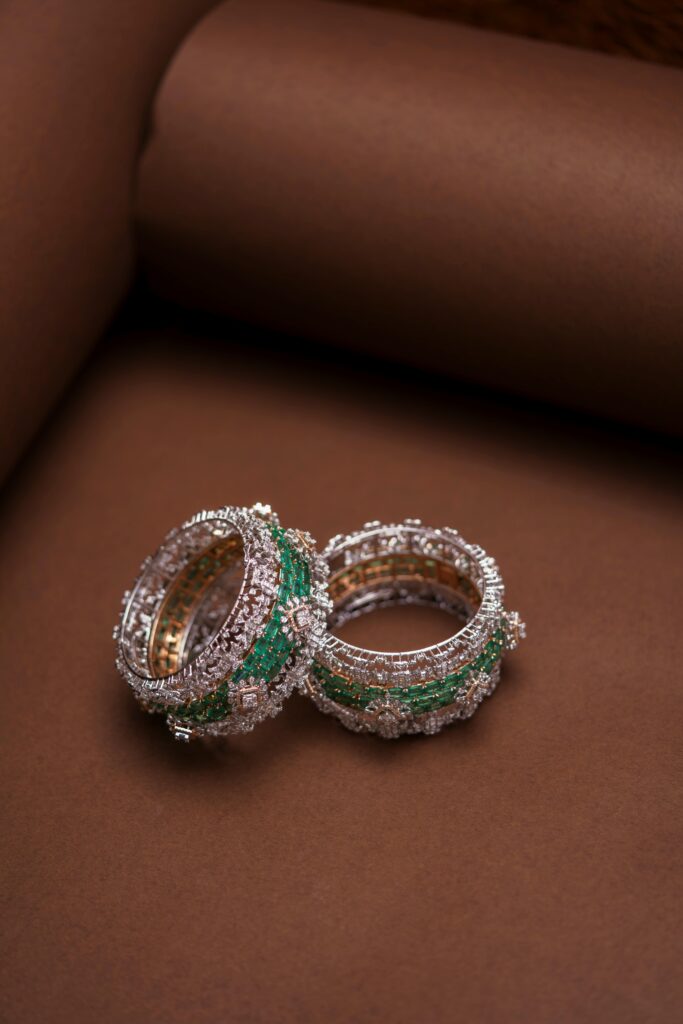 Close-up of Indian Swarovski crystal bangles on a brown backdrop, highlighting intricate design.