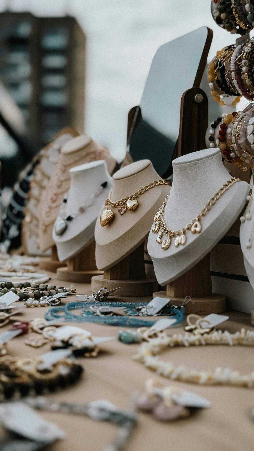 Chic display of necklaces and accessories at a street market. Urban shopping experience.